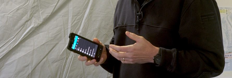 First responder holding a cell phone