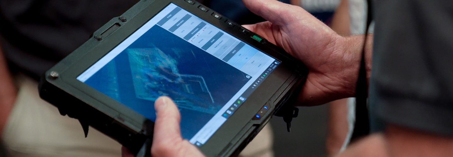 A researcher holds a tablet inside of the PSITC 