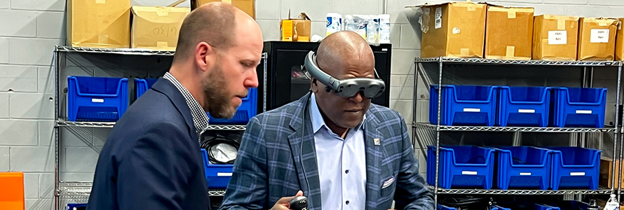 The First Responder Network Authority board chair Stephen Benjamin wearing a pair of virtual reality goggles during a lab tour.