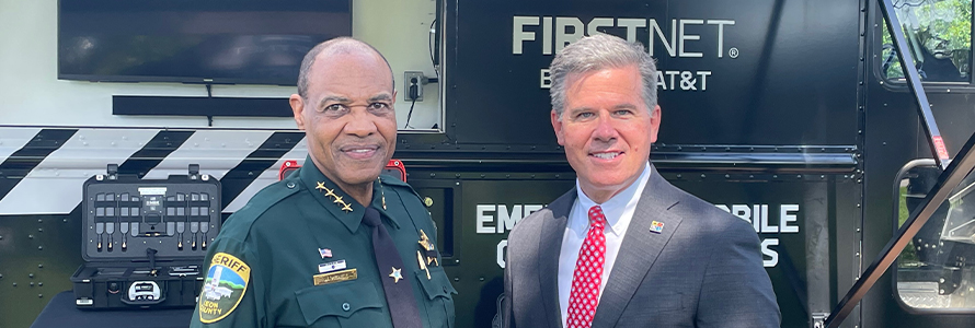 The sheriff of Leon County, Florida and FirstNet Authority Board Member Brian Crawford in front of a FirstNet emergency mobile communications vehicle.