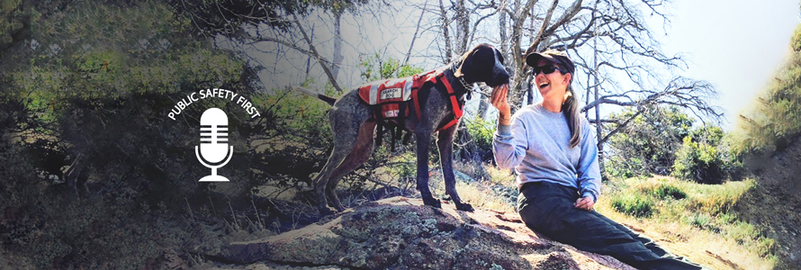 First responder in the woods with her search and rescue dog