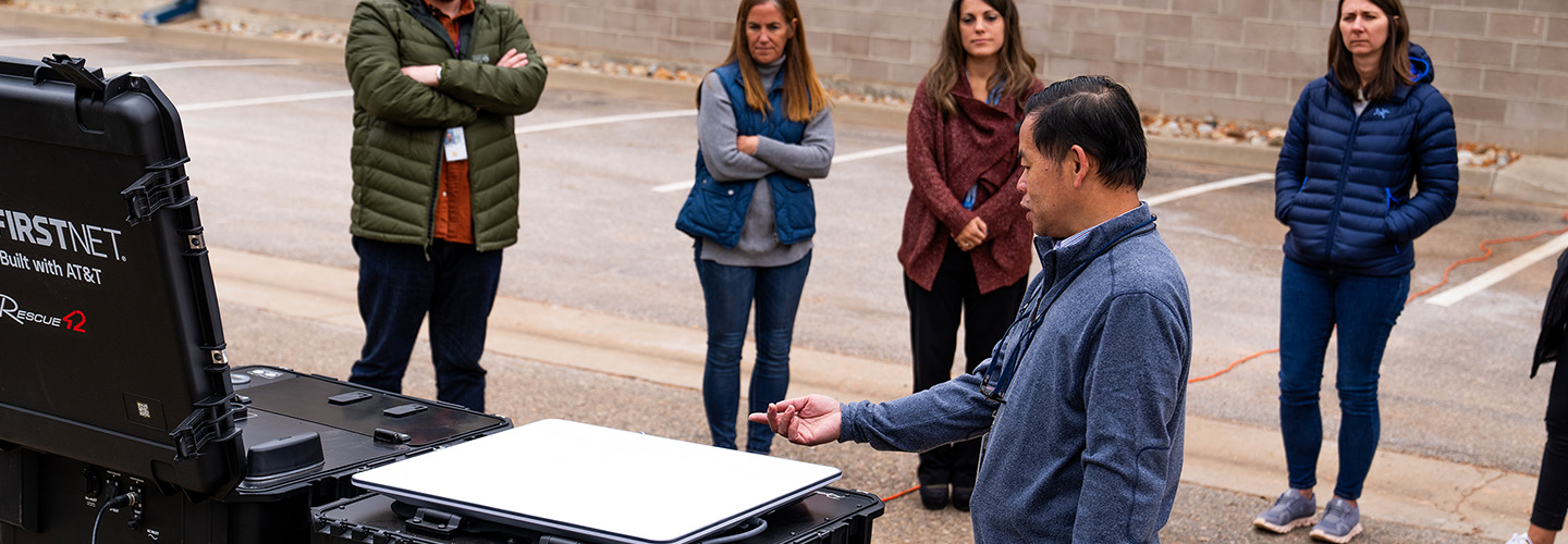 A FirstNet Authority staff member demonstrates a miniCRD outside the Boulder FirstNet Lab