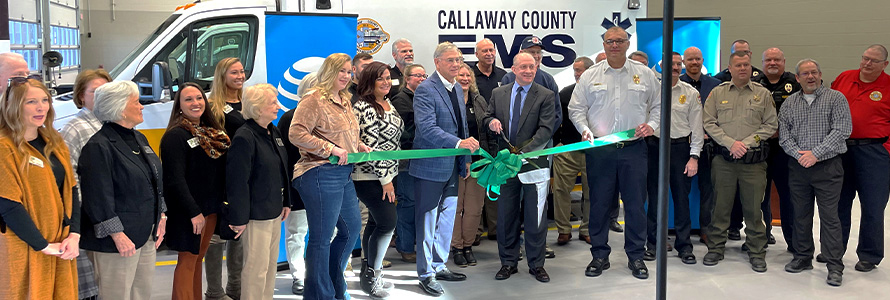 Local leaders cut a ribbon in front of a Callaway County EMS ambulance