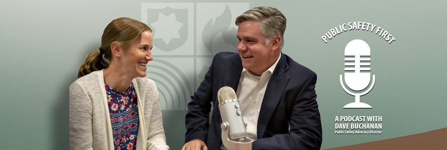 Host Dave Buchanan interviews Amanda Hilliard in front of a microphone on a table