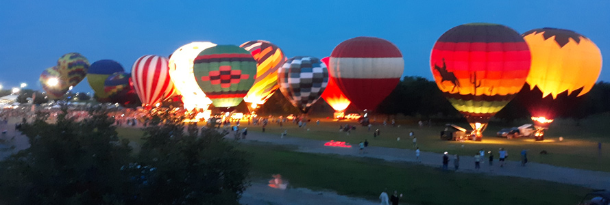 Hot-air balloon participate on a field glow at third annual FireLake Fireflight Balloon Festival in Shawnee, Oklahoma.