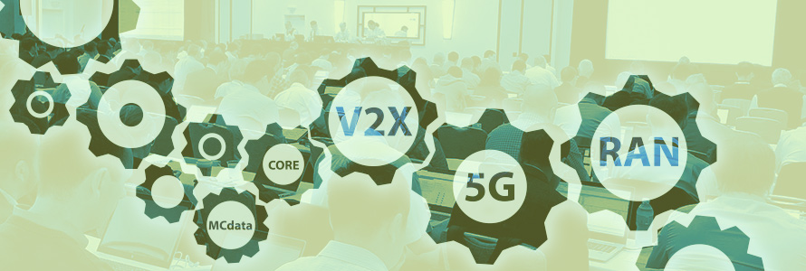 Photo of a 3GPP meeting room with people sitting at tables and working on computers, overlaid with gear icons and wireless network terminology: “RAN, 5G, V2X, Core, MCdata"