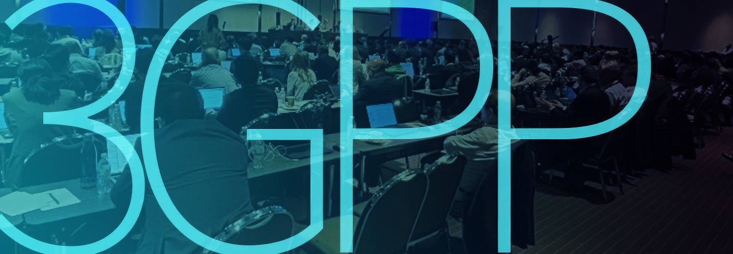 A large group of people dressed in business attire seated at conference tables while taking notes on electronic devices at a 3GPP plenary session in September 2024; "3GPP"   