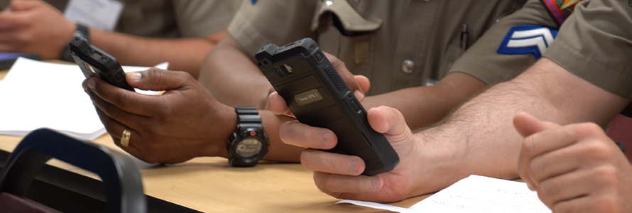 Close view of two FirstNet enabled smartphones held by responders