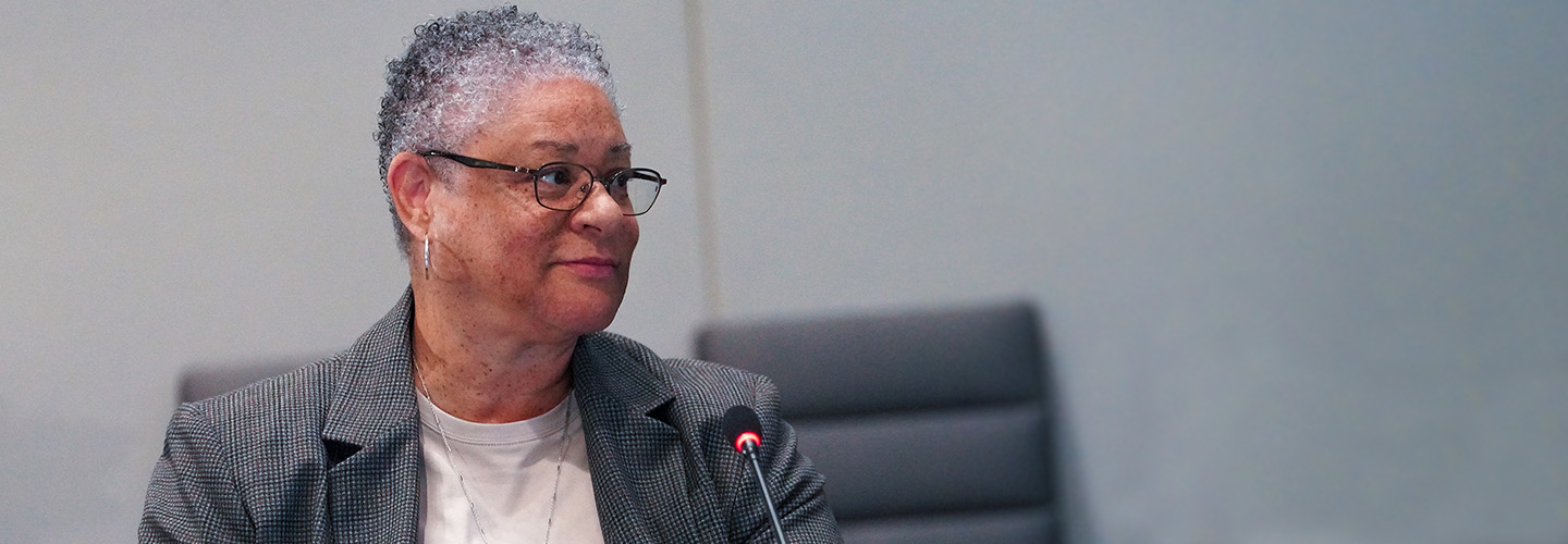 Renee Gordon in front of a microphone at a FirstNet Authority board meeting.