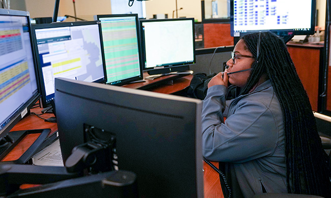 An Alexandria 9-1-1 call taker answers a call inside of the ECC