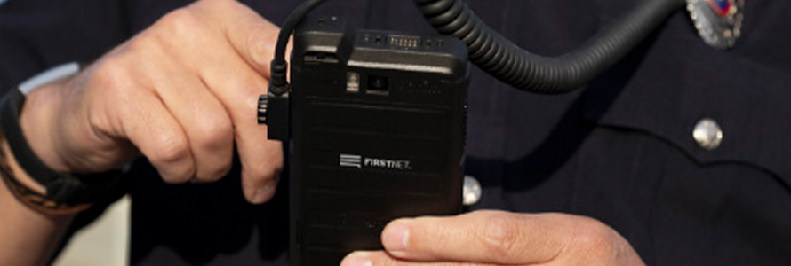 A first responder using FirstNet Push-to-Talk on a ruggedized smartphone