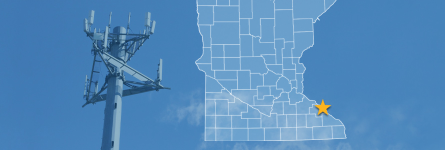 The state of Minnesota, with outlined county borders and a star locating the city of Kellogg; a cell tower