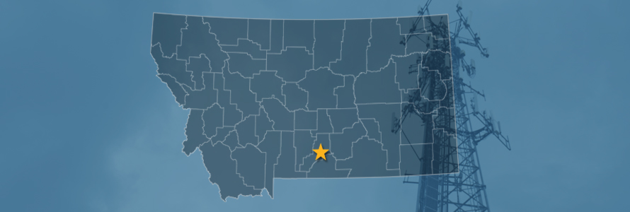 The state of Montana, with outlined county borders with a star locating Columbus, Montana; a cell tower.