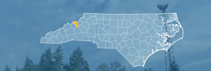 The state of North Carolina, with outlined county borders; a cell tower.