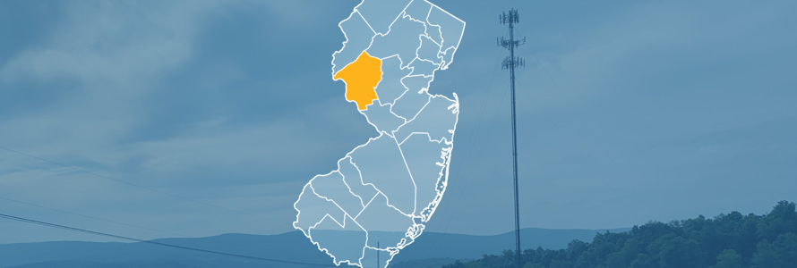 The state of New Jersey, with outlined county borders; a cell tower.