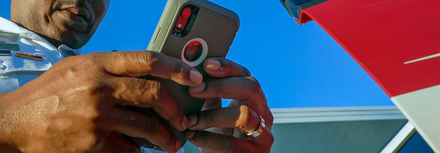 Close up of a smartphone in the hands of a public safety official