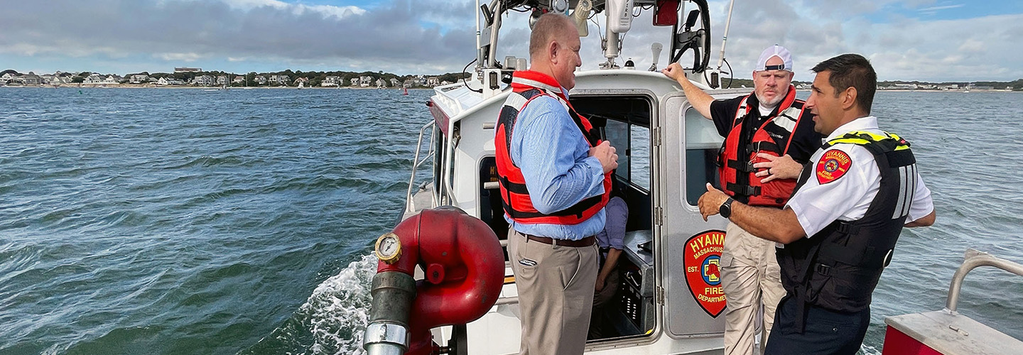 Public safety officials from Hyannis Fire speak with FirstNet Authority representatives while on an emergency response boat off the coast of Massachusetts.