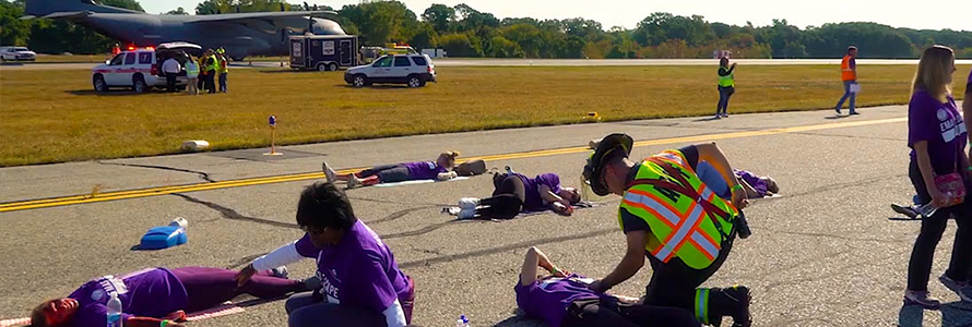 During a large-scale incident at an airport, first responders are attending crash victims on runway.