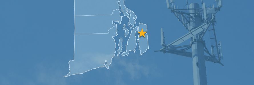 The state of Rhode Island, with outlined county borders and a star locating Tiverton, Rhode Island; a cell tower.