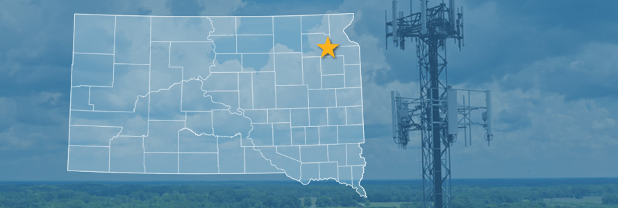 The state of South Dakota, with outlined county borders and star locating cell site; a cell tower.