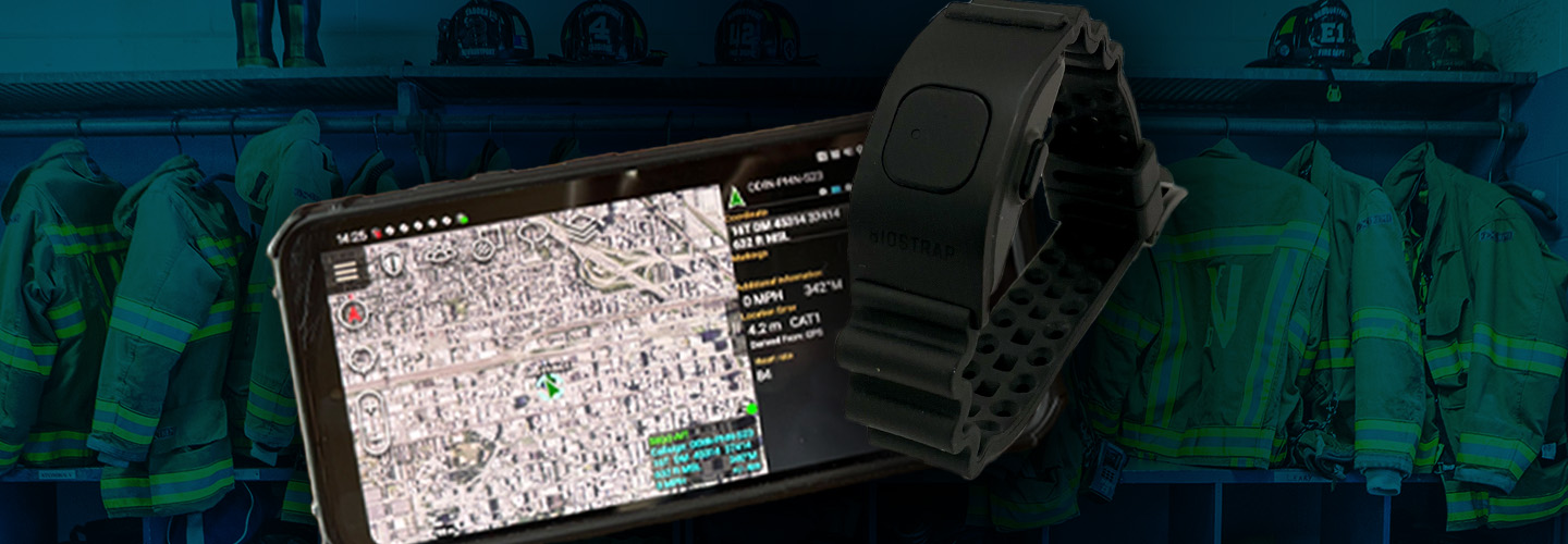 Smartphone displaying mapping location; wrist wearable device; background of firefighter uniforms hanging in a row. 