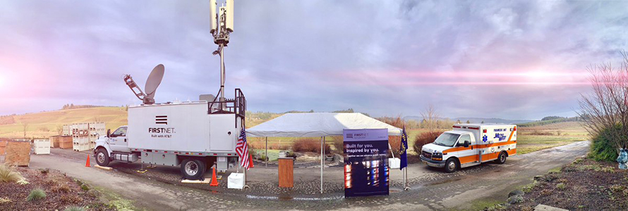 FirstNet Satellite Cell on Wheels, tent with FirstNet banner, and ambulance standing on road in Yamhill County, Oregon 