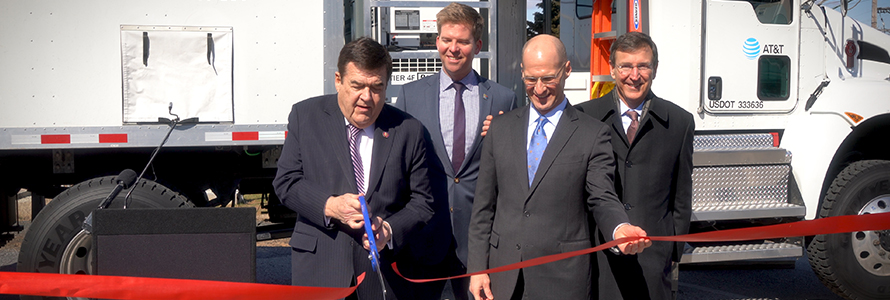 Congressman C.A. Dutch Ruppersberger cuts a red ribbon as FirstNet Authority Acting CEO Ed Parkinson looks on in front of an AT&T Satellite Cell on Light Truck