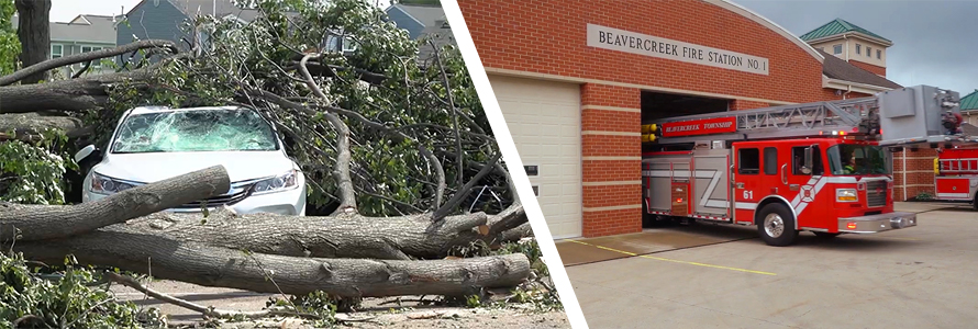 A car crushed by a fallen tree surrounded by branches and tree trunks; a Beavercreek Township fire truck leaves the fire station.