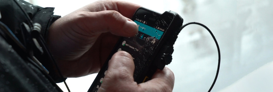 A first responder uses an application on a smartphone.