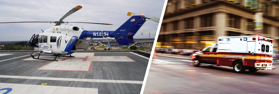 A University of Mississippi Medical Center helicopter on the roof of a medical facility and an ambulance driving on a city street.