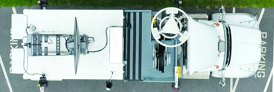 An aerial view of a Satellite Cell on Light Truck (SatCOLT) sitting in a parking lot.