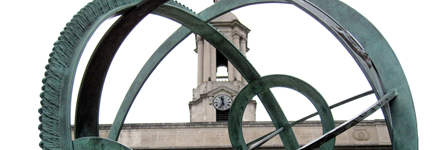 The Old Main Bell Tower sits behind the Old Main Armillary Sphere on the Pennsylvania State University campus.