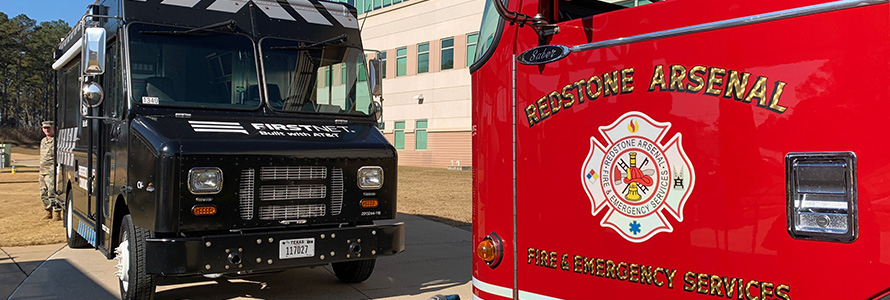 A Redstone Arsenal fire truck faces a FirstNet Emergency Mobile Communications Vehicle