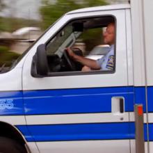 Bangs ambulance driver turning on a suburban road