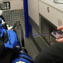 First responder in an ambulance holding a cell phone