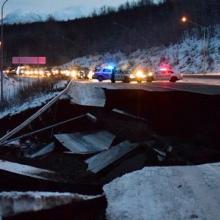 First responder vehicles on a highway destroyed by earthquake