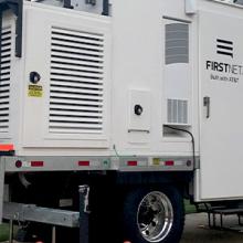 A SalColt parked outside next to a brick fence and cones A SalColt parked outside next to a brick fence and cones