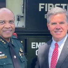 The sheriff of Leon County, Florida and FirstNet Authority Board Member Brian Crawford in front of a FirstNet emergency mobile communications vehicle.