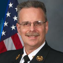 Episode 76: Voices from the Field: International Firefighters’ Day 2024 Public Safety First podcast logo; soundwaves; headshot of Chesterfield County Fire & EMS Chief Loy Senter