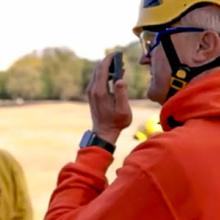 Santa Clara responder speaks into a smartphone while in the field