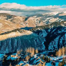 Aerial view of lodges and snow-covered mountains during the day in Eagle County, Colorado