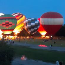 Hot-air balloon participate on a field glow at third annual FireLake Fireflight Balloon Festival in Shawnee, Oklahoma.