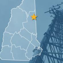 The State of New Hampshire, with outlined county borders and star locating Conway, New Hampshire; a cell tower. 