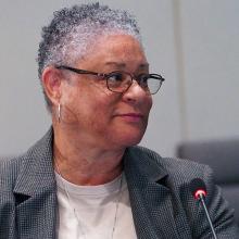 Renee Gordon in front of a microphone at a FirstNet Authority board meeting.