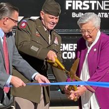 Deputy Commanding General of Army Materiel Command Lieutenant General Donnie Walker cuts a ribbon held by FirstNet Authority Board member Chief Richard Carrizzo, Alabama Governor Kay Ivey, and AT&T Alabama President Wayne Hutchens in front of a FirstNet Emergency Mobile Communications truck.