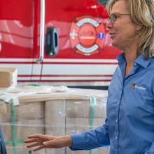 Boulder Fire-Rescue Chief Michael Calderazzo and FirstNet Authority Senior Public Safety Advisor Tracey Murdock stand talking in front of a fire truck