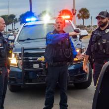 Coordinated response: How citywide FirstNet deployments benefit law enforcement Six police officers talking in front of three police vehicles at an intersection in St. Augustine, Florida