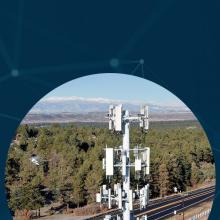 An interconnected network backdrop with three images of FirstNet towers, including a tower overlooking mountains, forest and a lake; a tower situated near a road and forest; and a FirstNet tower near a green open field surrounded by a dense forest.