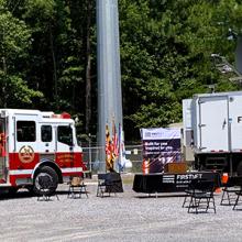 Fire truck and FirstNet Satellite Cell on Light Truck parked in front of a cell tower