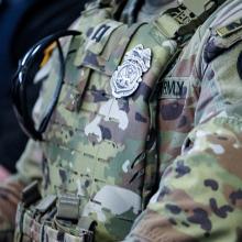 An army military police officer using a FirstNet enabled cell phone